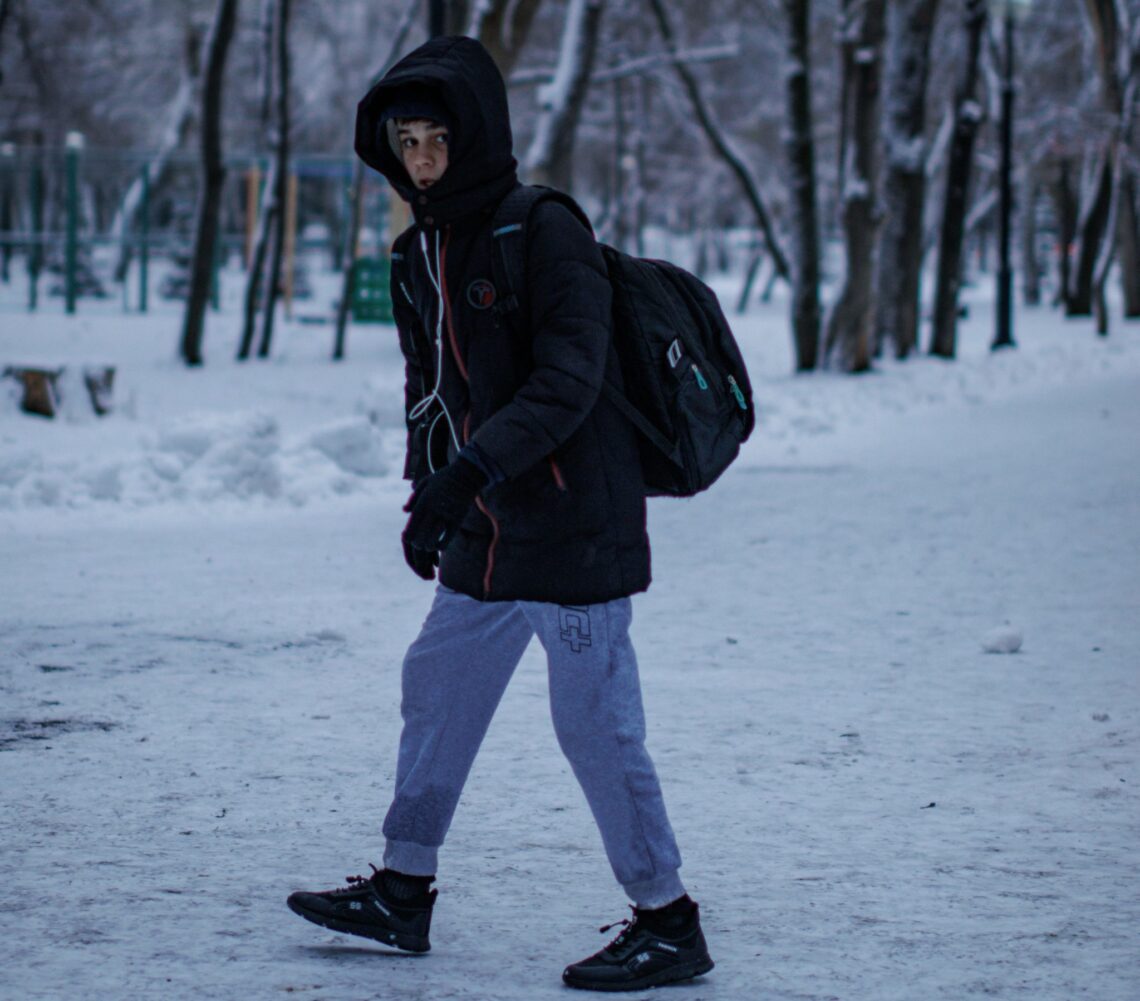 youth walking alone in the snow
